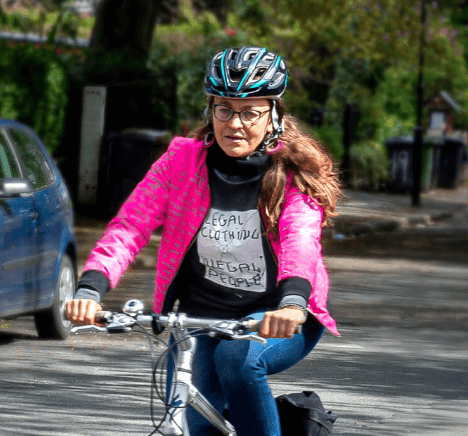A photograph from the Leeds city Council: Walk it Ride it campaign of a woman cycling along a tree lined street in Leeds.