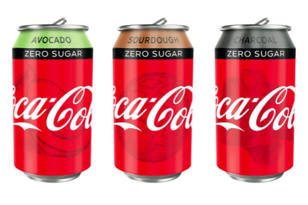 Three Coca Cola cans in a row.