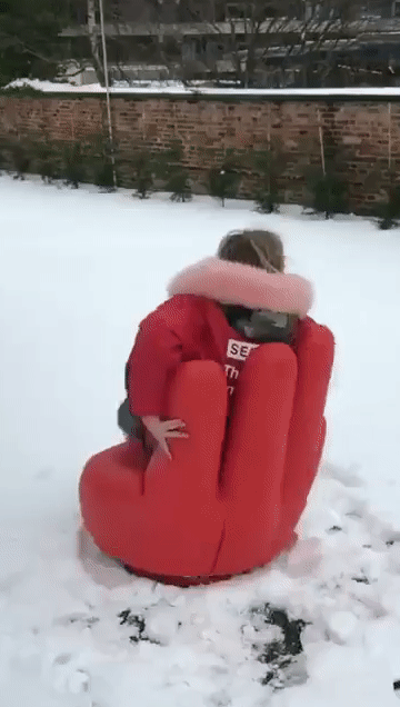 Kristi spinning on a chair in the snow.