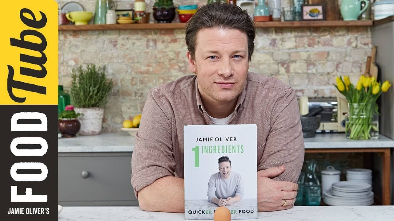 Image of TV chef Jamie Oliver with a cookbook.