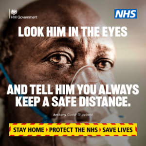 Government Covid campaign poster featuring bald black man wearing aged around 65 wearing oxygen mask. Text reads Look him in the eyes and tell him you always keep a safe distance 
