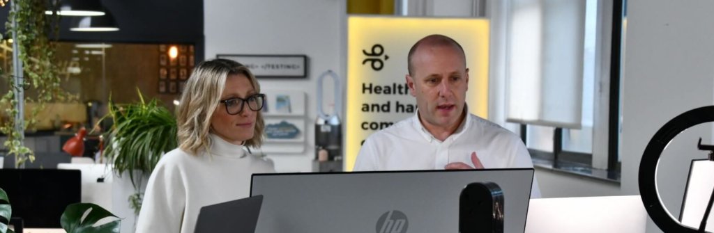 Image of Kim and Tom looking at screens during webinar