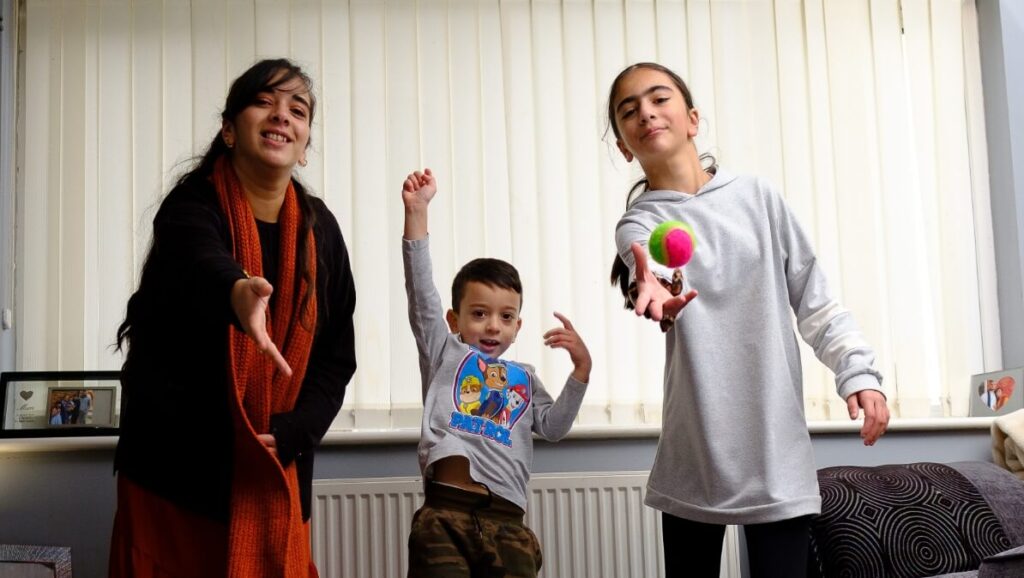 3 children facing the camera in animated and active stances
