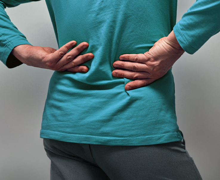 Person holding their back in pain